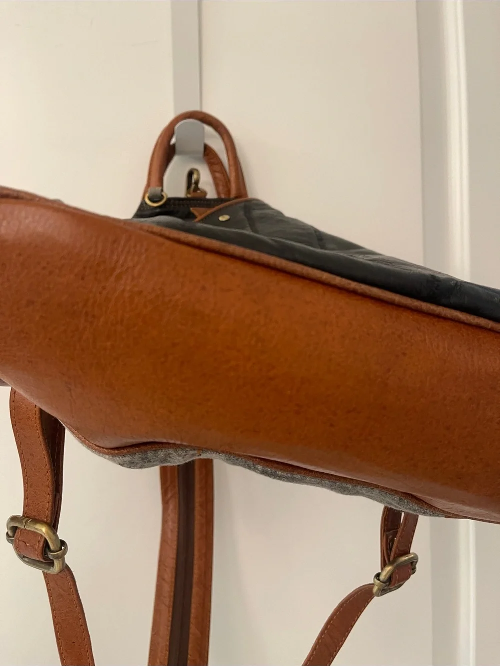 Black Leather Backpack with Brown Trim and Brass Accents
